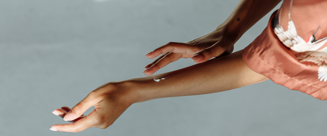 female applying moisturizer on her arm